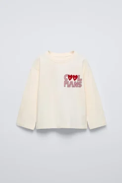 Niños ZARA 1½ - 6 Años·Camisetas|6 - 18 Meses·Camisetas<CAMISETA TEXTO FLOCK